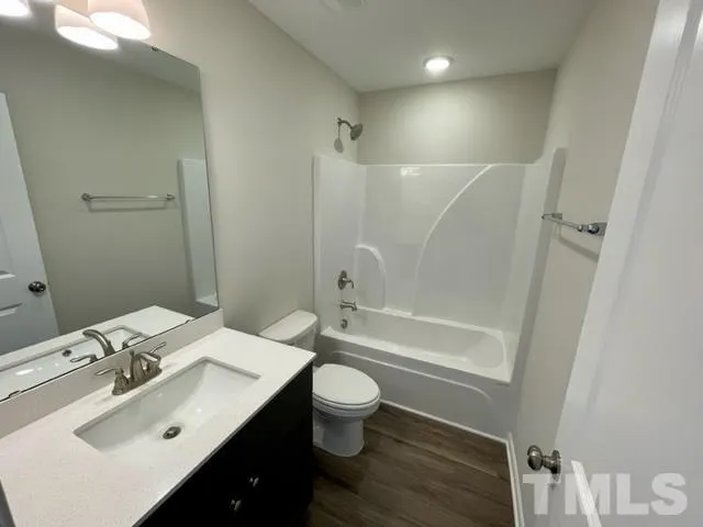 a bathroom with a sink toilet tub and shower