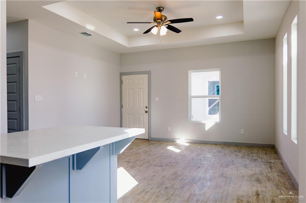 3052 Briggs Road, Unit B Weslaco, TX 78596 - Photo 4 of 12 wooden floor in an empty room with a window