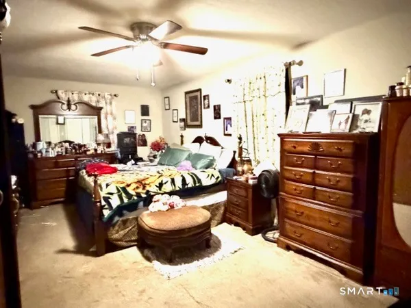 a bedroom with bed and a window