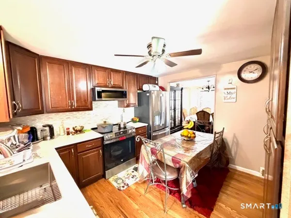 a kitchen with stainless steel appliances granite countertop a refrigerator stove and sink