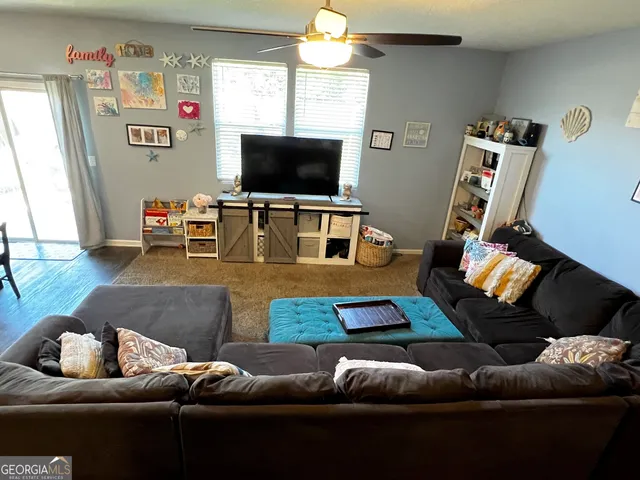 a living room with furniture and a flat screen tv