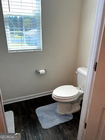 a bathroom with a toilet and a window