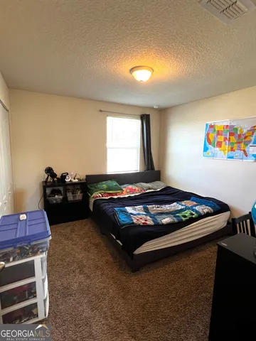 a bedroom with furniture and a window
