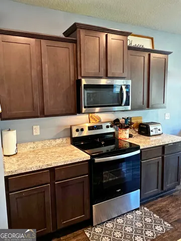 a kitchen with a sink stove and microwave