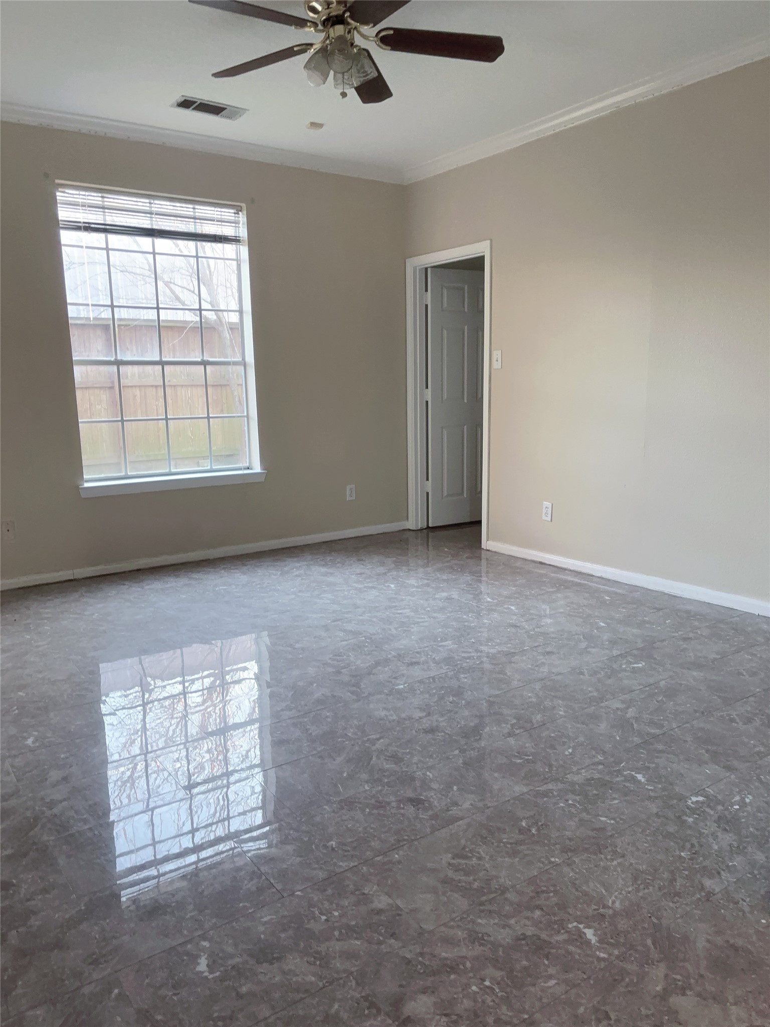 6131 East Houston Road Houston, TX 77028 - Photo 3 of 8 an empty room with windows and fan