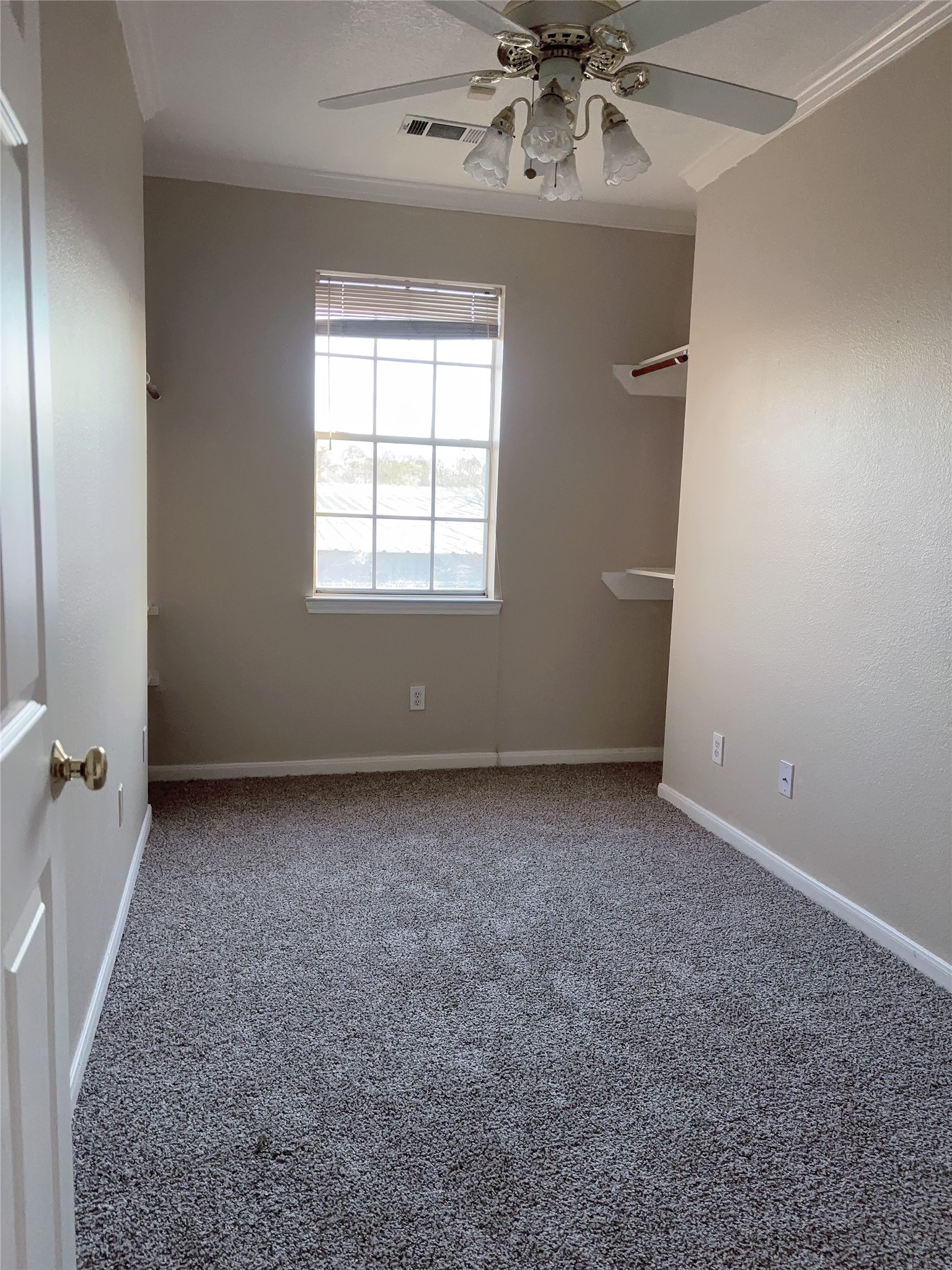 6131 East Houston Road Houston, TX 77028 - Photo 5 of 8 an empty room with a chandelier fan and windows
