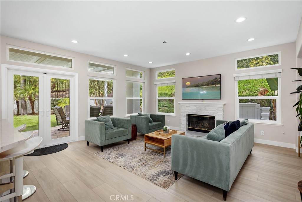 27121 Woodbluff Road Laguna Hills, CA 92653 - Photo 11 of 30 a living room with furniture and a fireplace