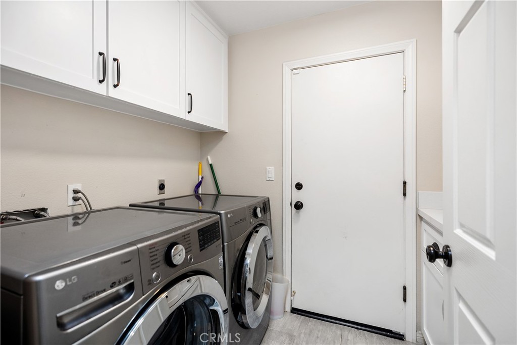 27121 Woodbluff Road Laguna Hills, CA 92653 - Photo 14 of 30 a utility room with dryer and washer