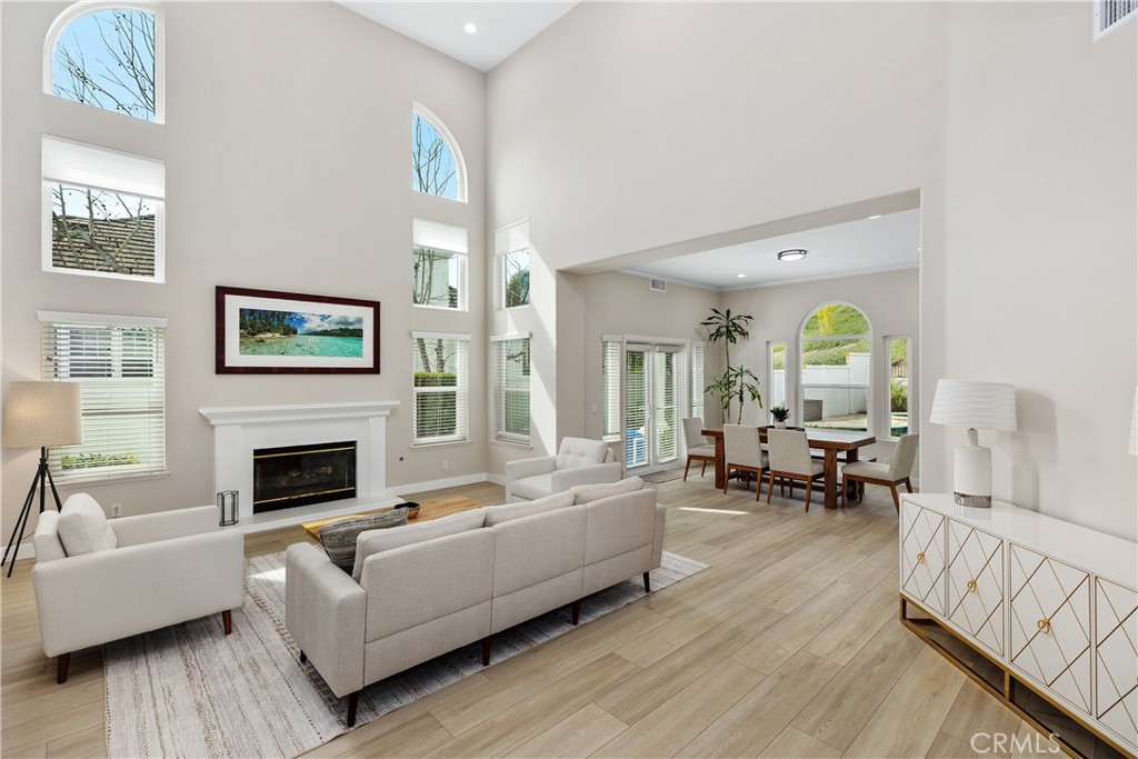 27121 Woodbluff Road Laguna Hills, CA 92653 - Photo 2 of 30 a living room with furniture fireplace and a table