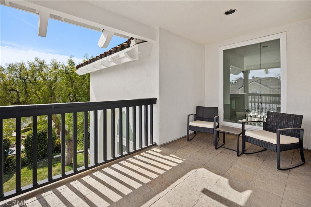 27121 Woodbluff Road Laguna Hills, CA 92653 - Photo 22 of 30 a balcony with wooden floor and furniture