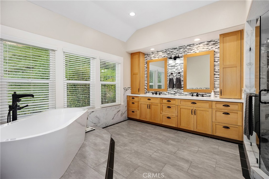 27121 Woodbluff Road Laguna Hills, CA 92653 - Photo 24 of 30 a spacious bathroom with a double vanity sink large mirror and a bathtub