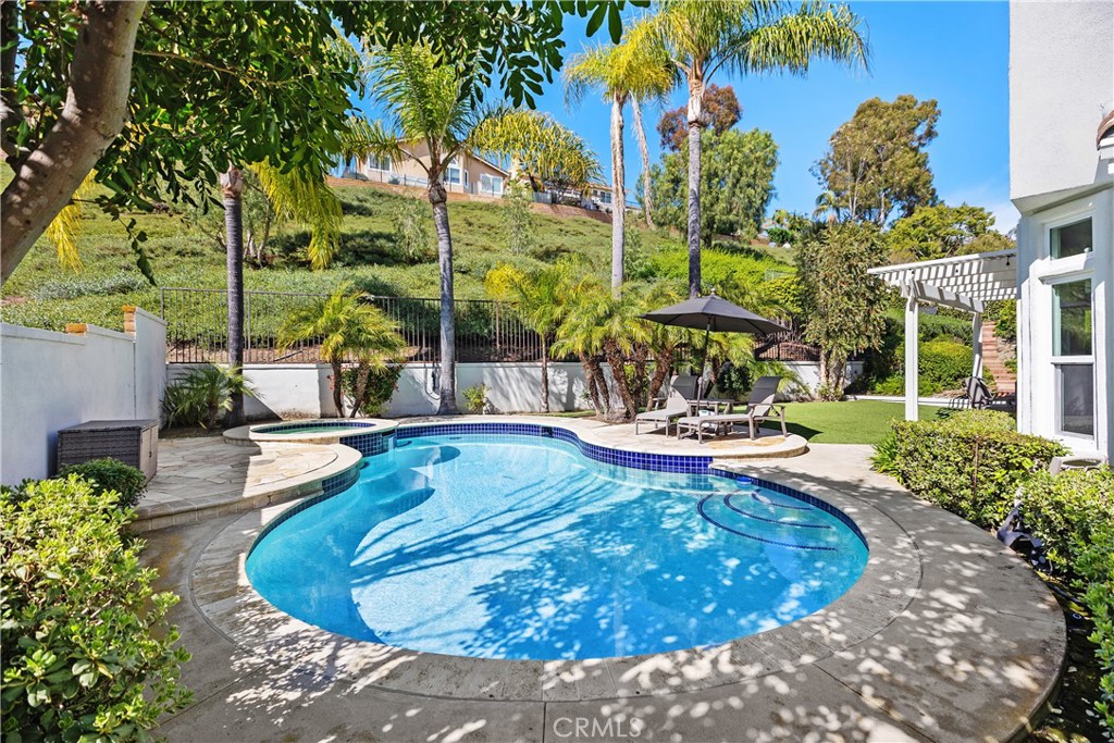27121 Woodbluff Road Laguna Hills, CA 92653 - Photo 29 of 30 a view of a swimming pool with a patio