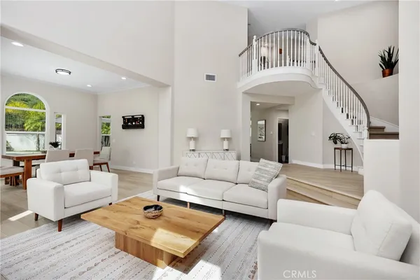 a living room with furniture a rug and a chandelier