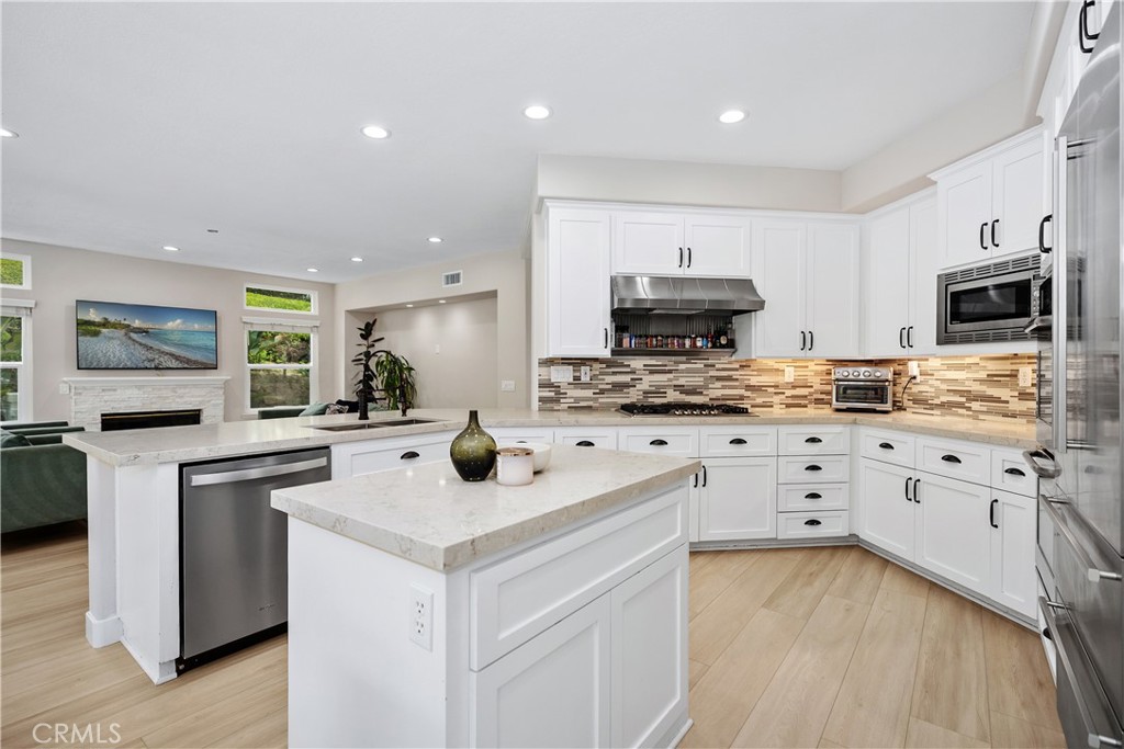 27121 Woodbluff Road Laguna Hills, CA 92653 - Photo 7 of 30 a kitchen with granite countertop a sink stove and cabinets