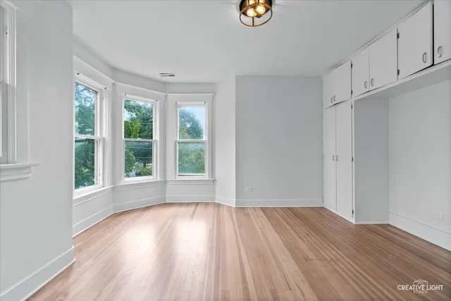 a view of wooden floor and windows in a room