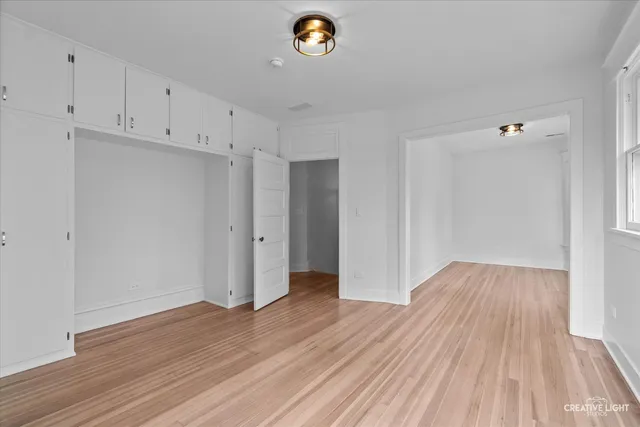 a view of an empty room and wooden floor