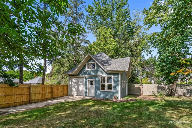 a view of a house with a yard and sitting area