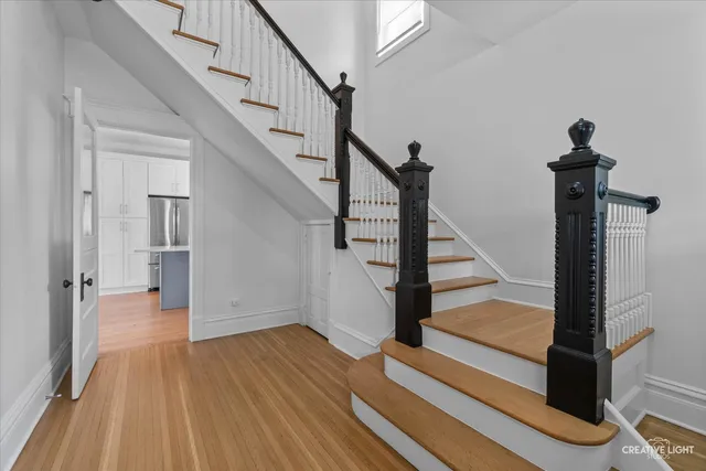 a view of entryway with wooden floor and stairs