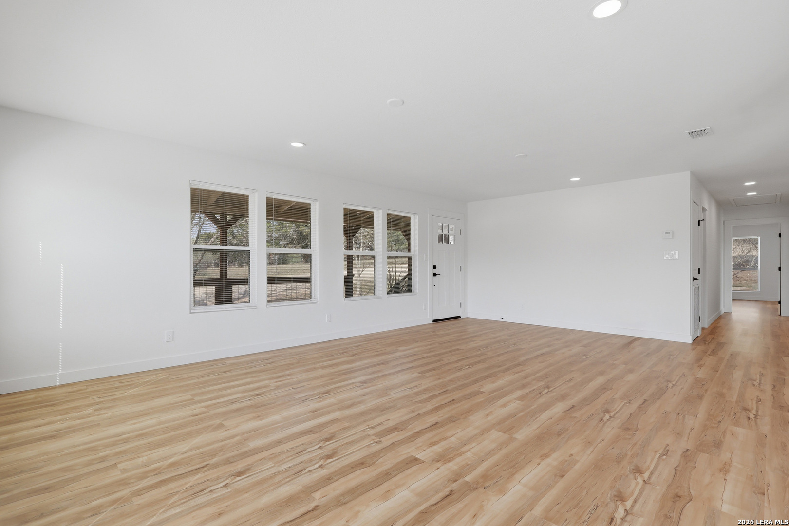 1333 Comanche Path Bandera, TX 78003 - Photo 11 of 41 a view of an empty room with a window and wooden floor