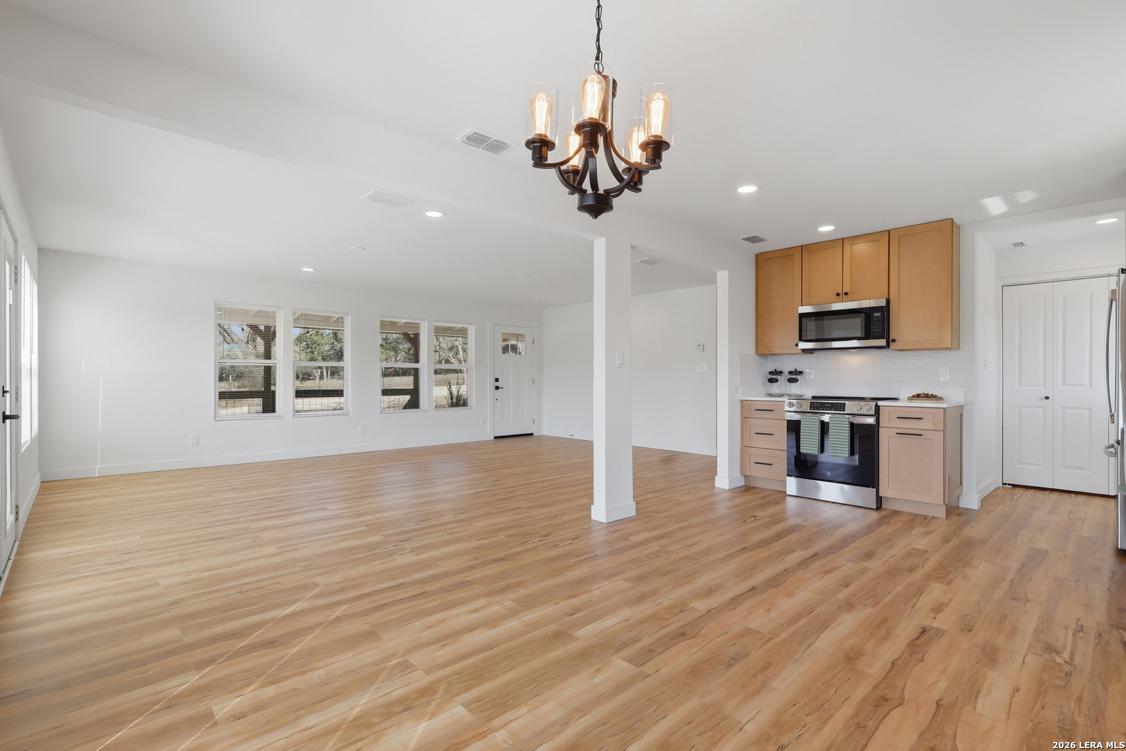 1333 Comanche Path Bandera, TX 78003 - Photo 14 of 41 a view of a kitchen with a sink and dishwasher a stove top oven with wooden floor