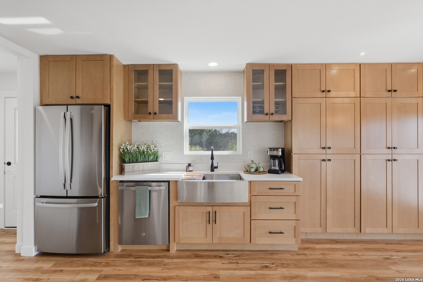 1333 Comanche Path Bandera, TX 78003 - Photo 16 of 41 a kitchen with a refrigerator and a sink