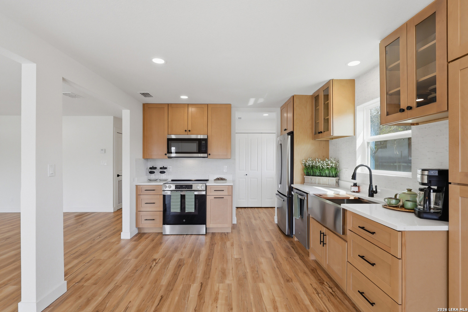 1333 Comanche Path Bandera, TX 78003 - Photo 18 of 41 a kitchen with stainless steel appliances granite countertop a stove top oven a sink dishwasher a refrigerator and cabinets with wooden floor