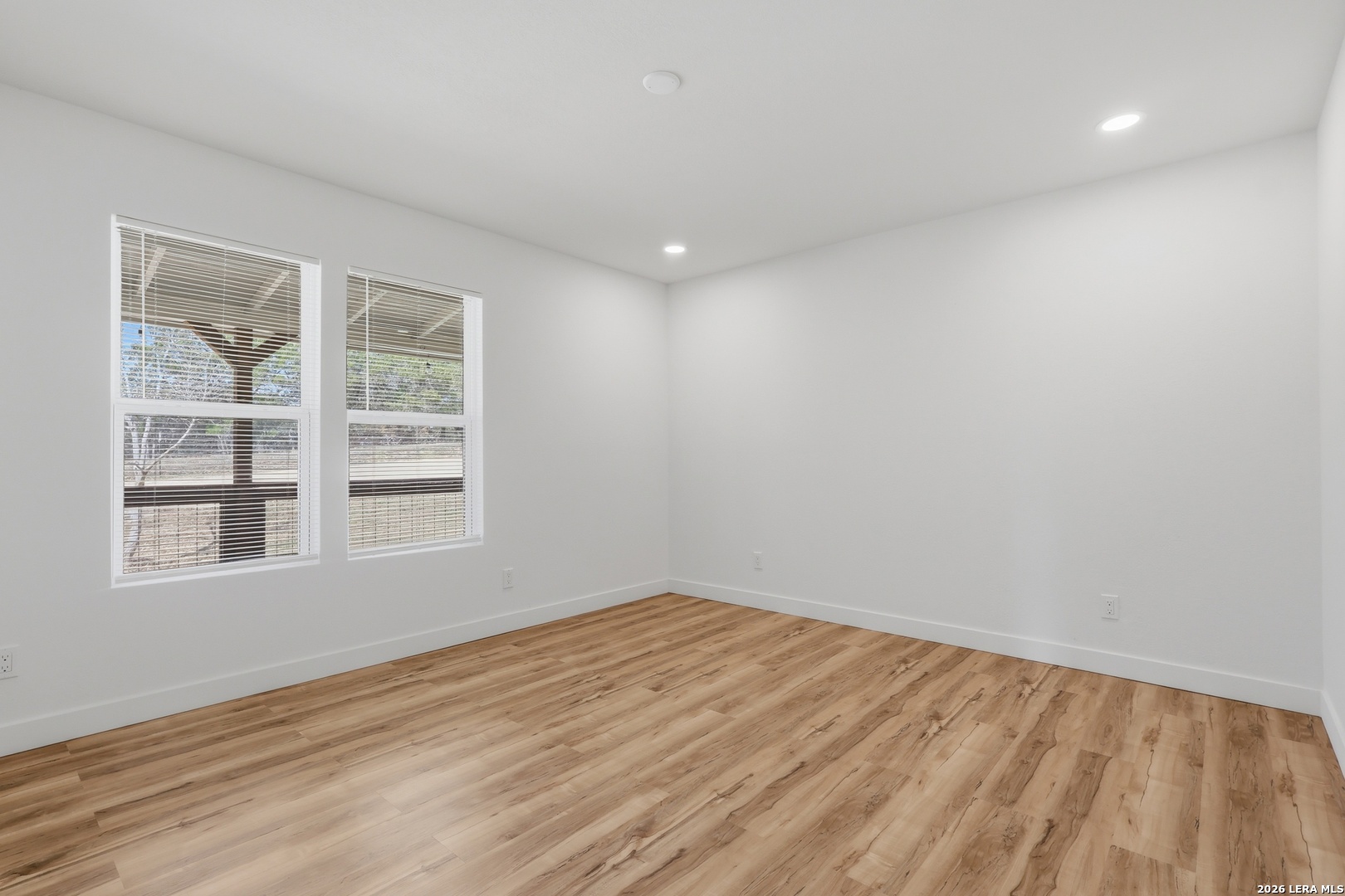 1333 Comanche Path Bandera, TX 78003 - Photo 20 of 41 a view of empty room with wooden floor and fan