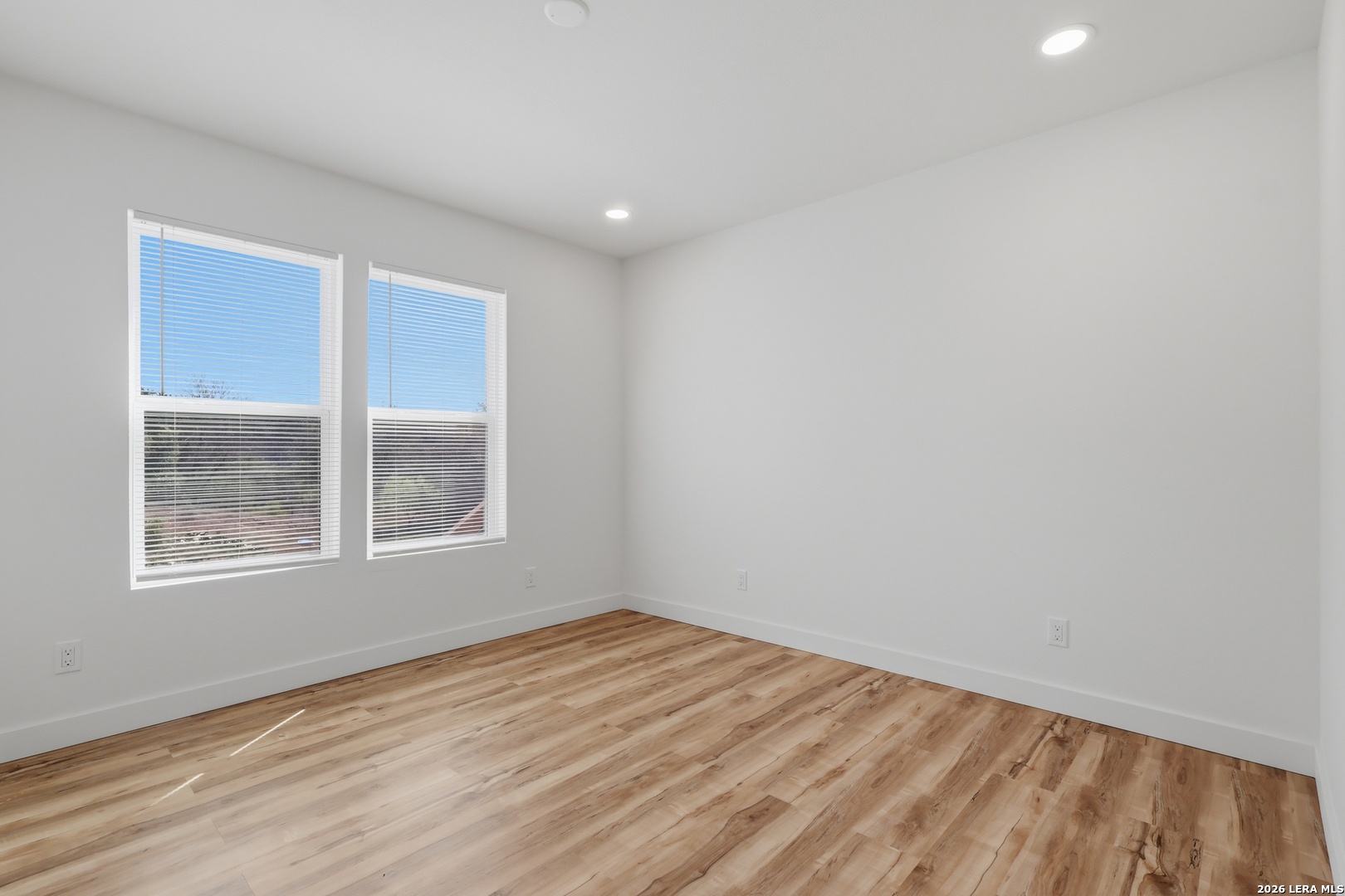 1333 Comanche Path Bandera, TX 78003 - Photo 23 of 41 an empty room with wooden floor and windows