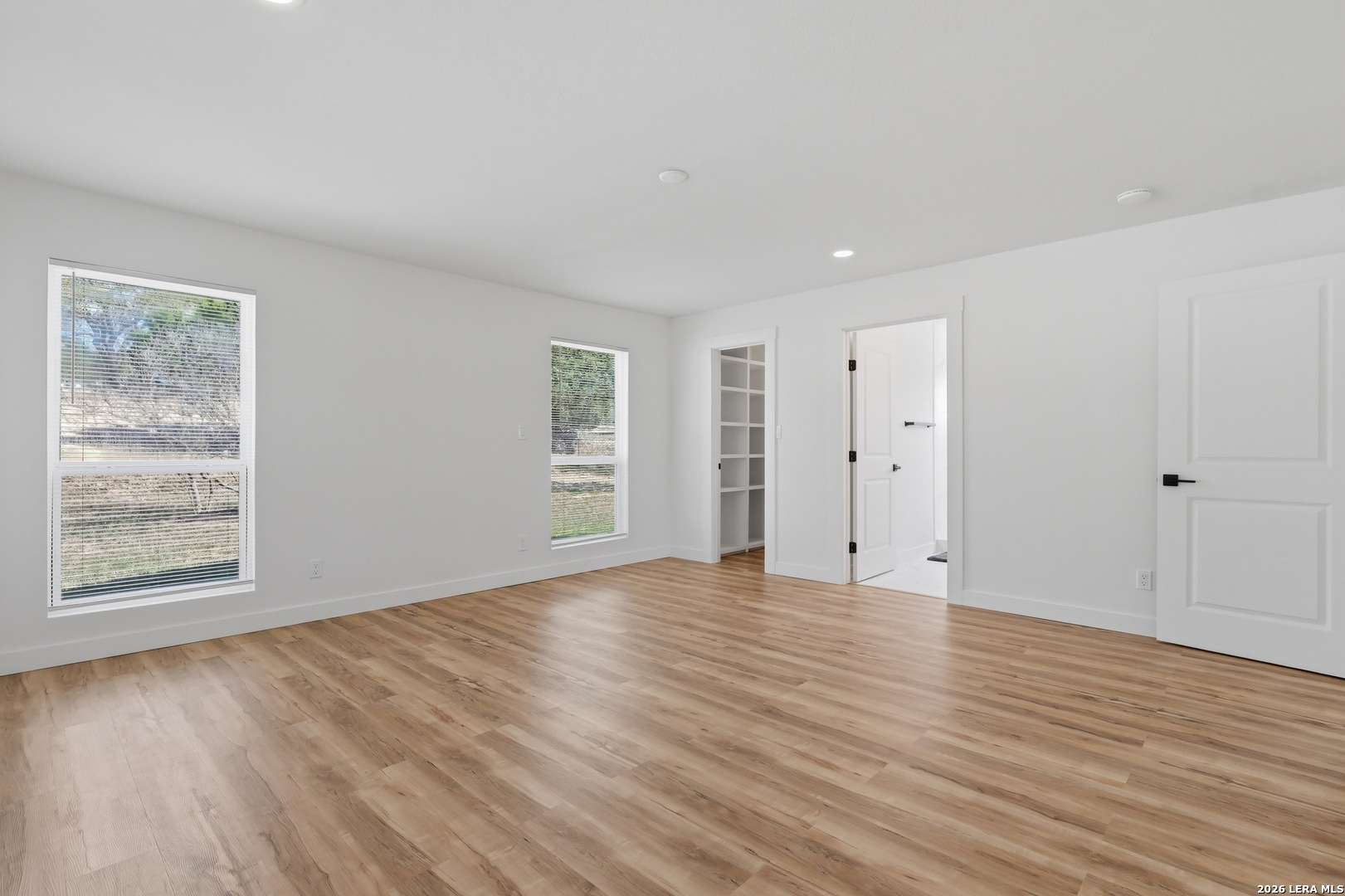 1333 Comanche Path Bandera, TX 78003 - Photo 28 of 41 a view of an empty room with wooden floor and a window