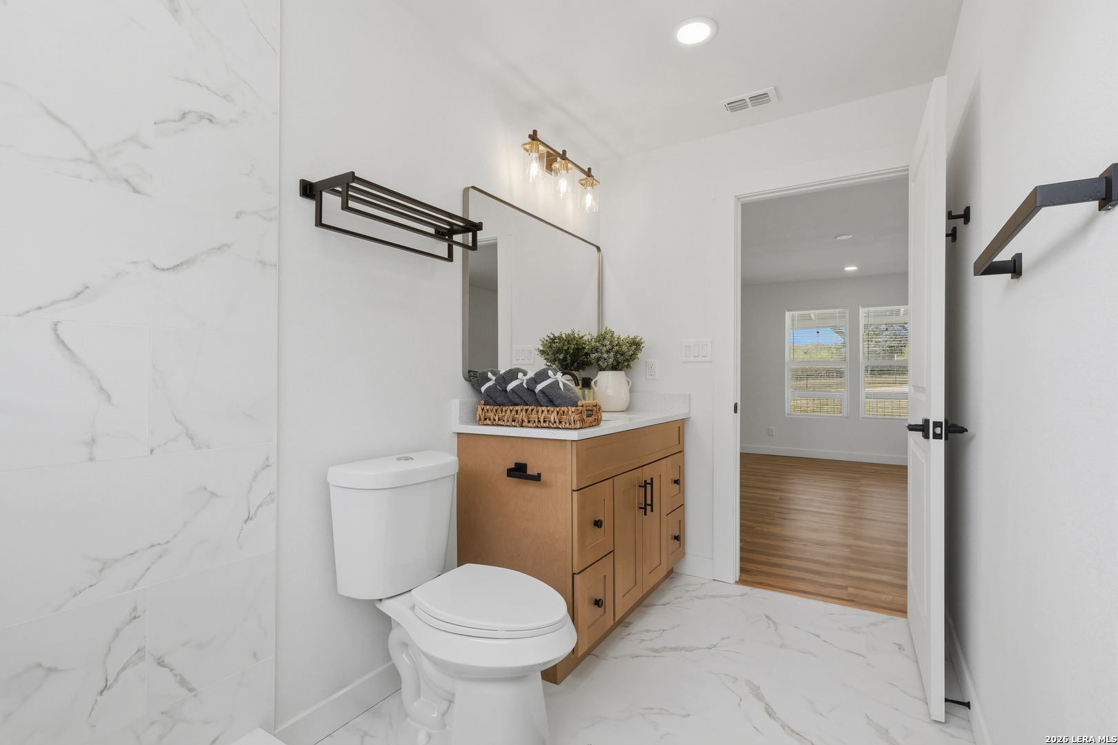 1333 Comanche Path Bandera, TX 78003 - Photo 31 of 41 a bathroom with a sink vanity mirror and toilet