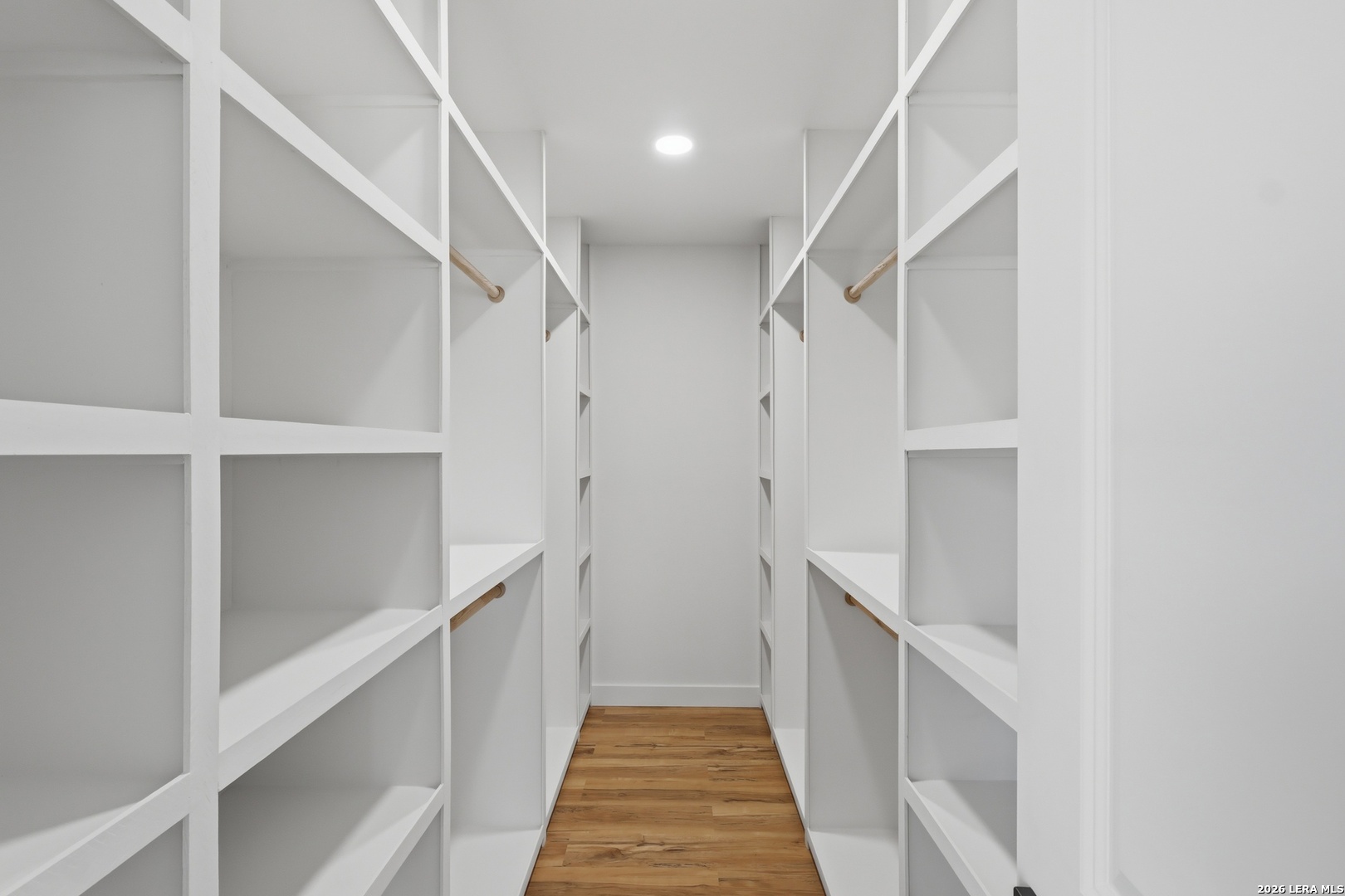 1333 Comanche Path Bandera, TX 78003 - Photo 32 of 41 a hallway with white cabinets and a white walls