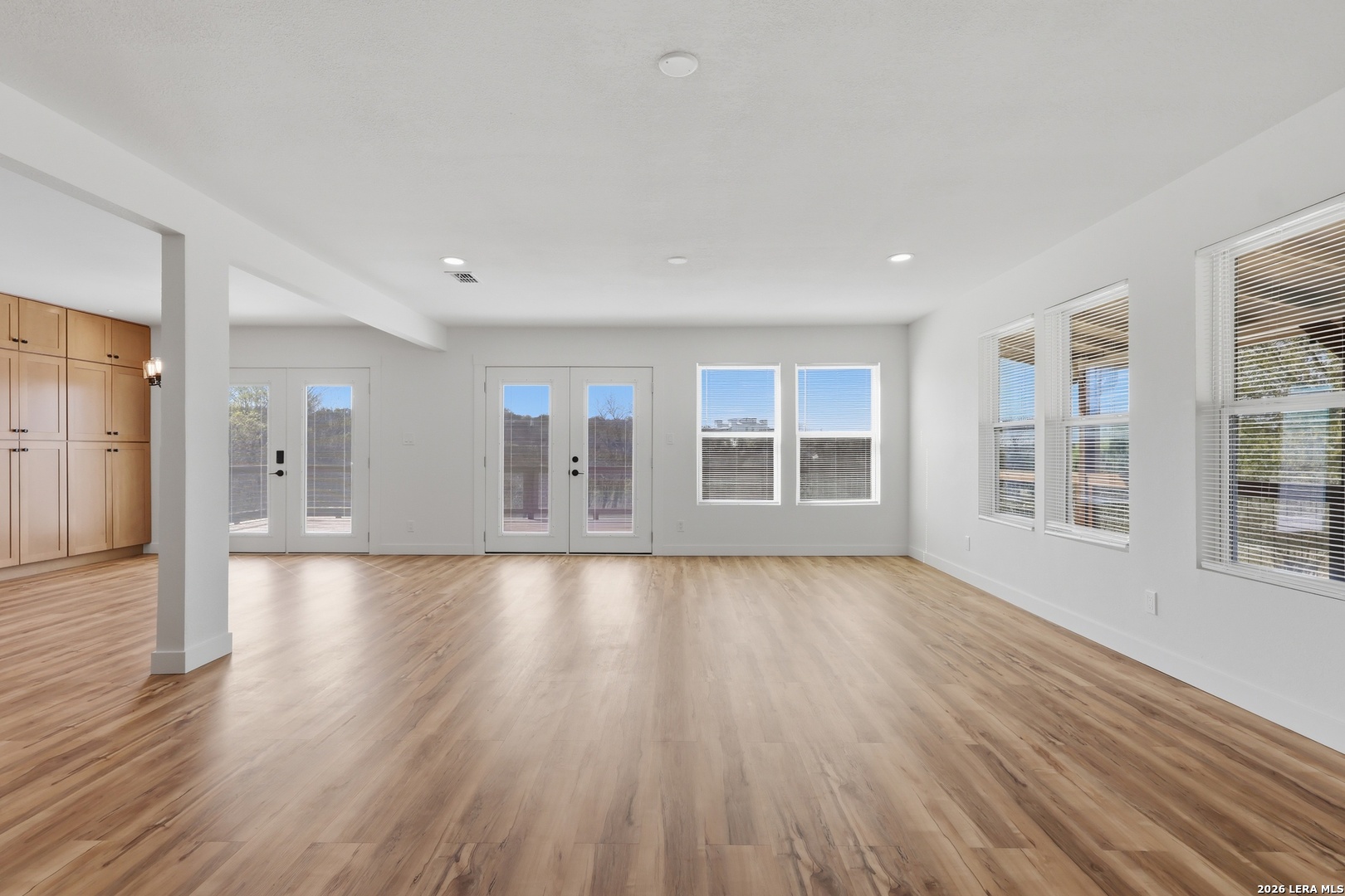 1333 Comanche Path Bandera, TX 78003 - Photo 10 of 41 a view of empty room with wooden floor and windows