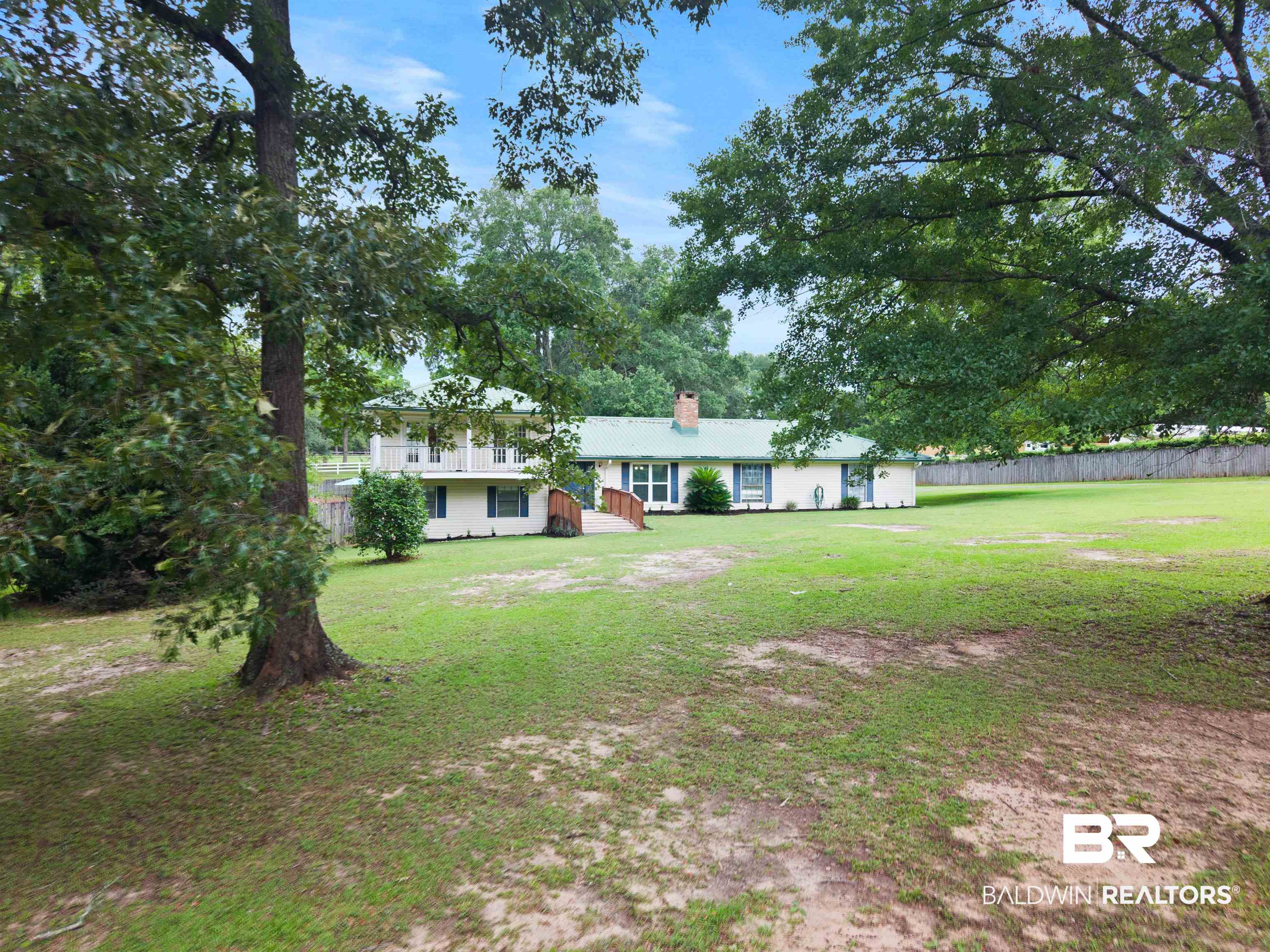10420 Johnson Road South Mobile, AL 36695 - Photo 6 of 75 Expansive green lawn surrounding a residence with a green metal roof and white siding