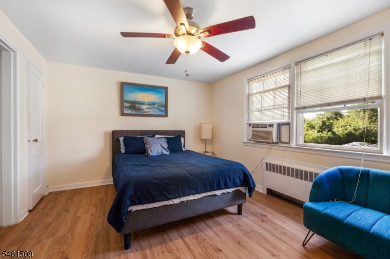 445 Morris Avenue, Unit 4 Springfield, NJ 07081 - Photo 6 of 11 a bedroom with a large bed couch and window