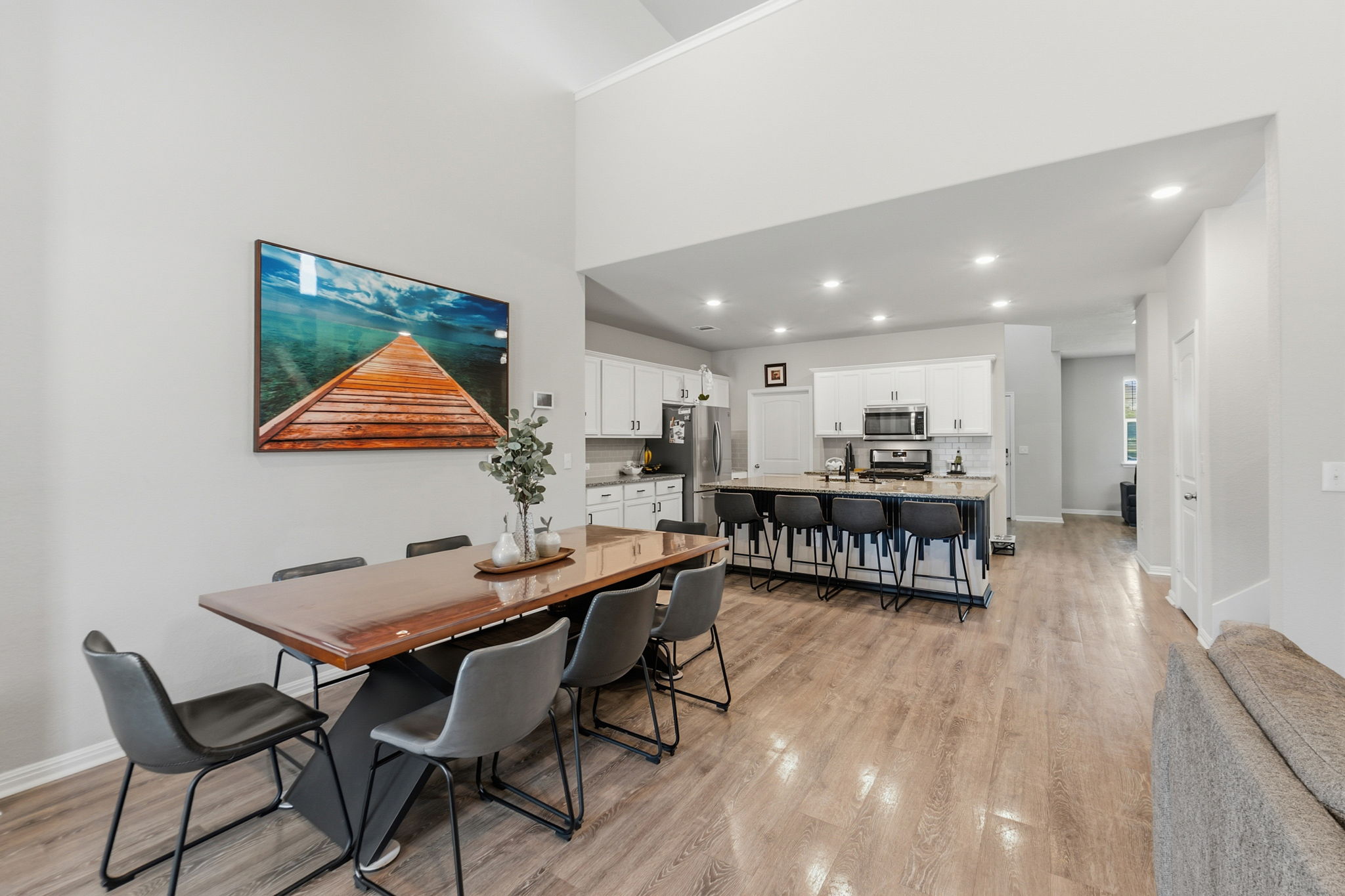 142 Brunnen Way Georgetown, TX 78626 - Photo 5 of 22 Soaring ceilings complement the open-concept layout of this inviting dining and kitchen area, perfect for entertaining.