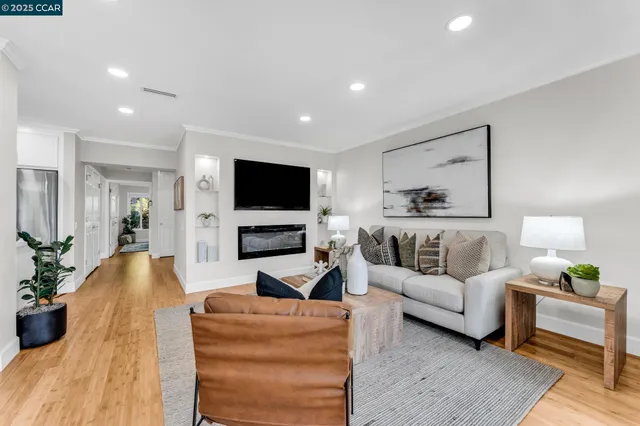 a living room with furniture a flat screen tv and a fireplace