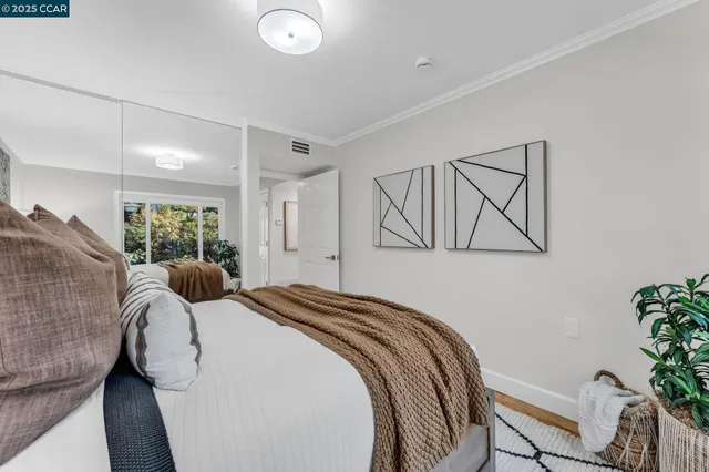 a bed sitting in a bedroom next to a window