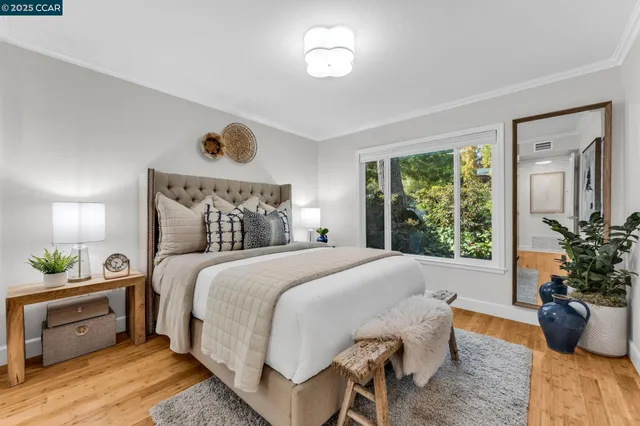 a bedroom with a bed and a potted plant