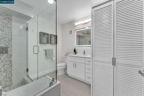 a bathroom with a toilet a sink and shower