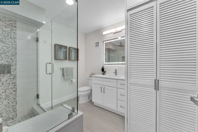 a bathroom with a toilet a sink and shower