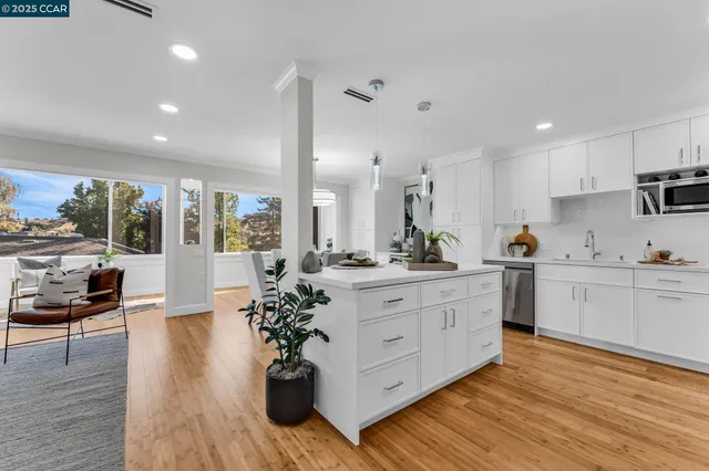 a kitchen with white cabinets and appliances
