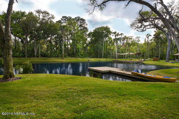 1126 Neck Road Ponte Vedra Beach, FL 32082 - Photo 13 of 32 a view of a lake with a yard and a bench