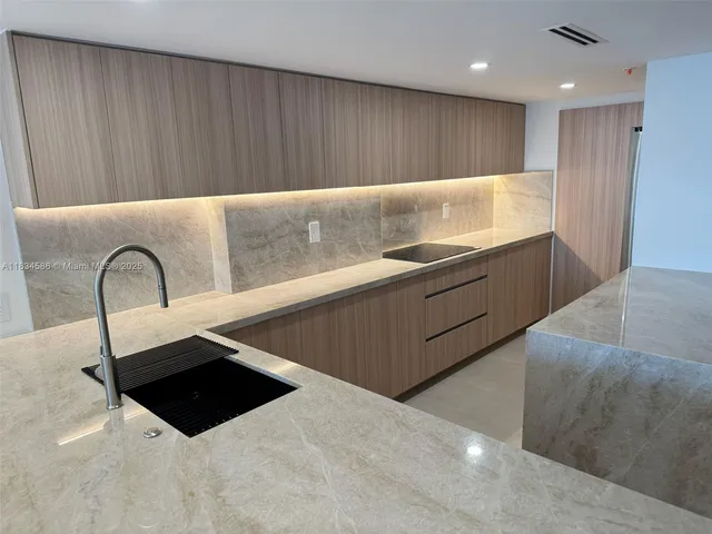 a kitchen with a cabinets and window