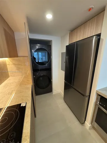 a kitchen with a refrigerator and a stove
