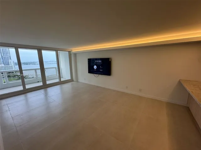 a view of an empty room with a window