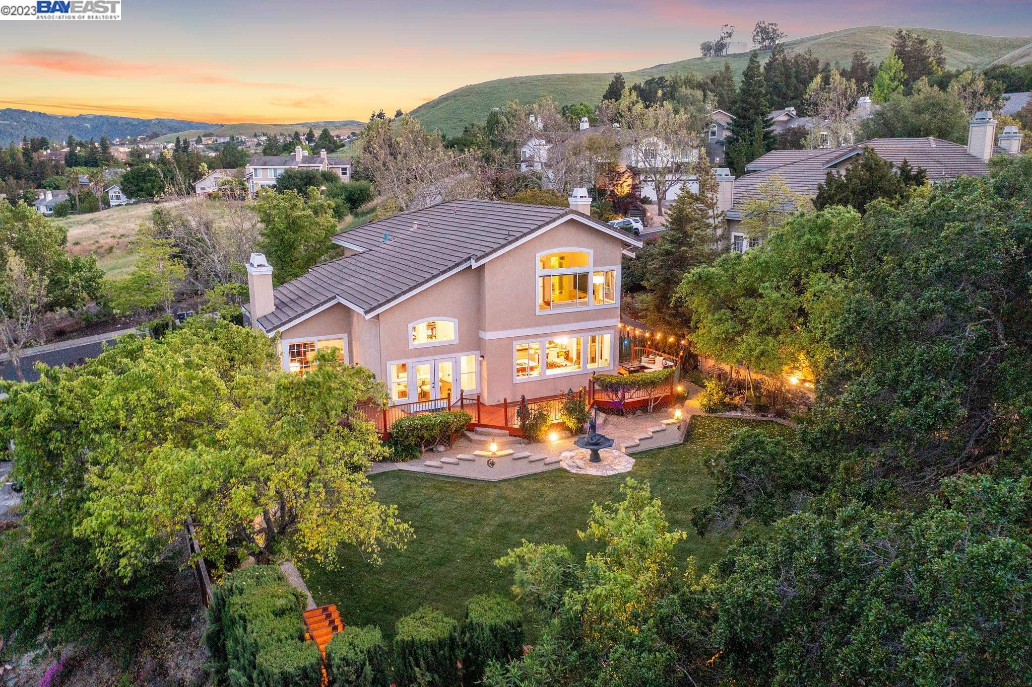 an aerial view of a house with a yard basket ball court and outdoor seating