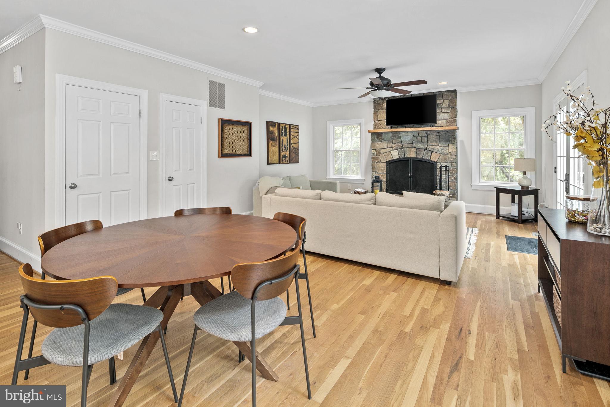 6916 Seven Locks Road Cabin John, MD 20818 - Photo 16 of 38 a living room with furniture a fireplace and a flat screen tv