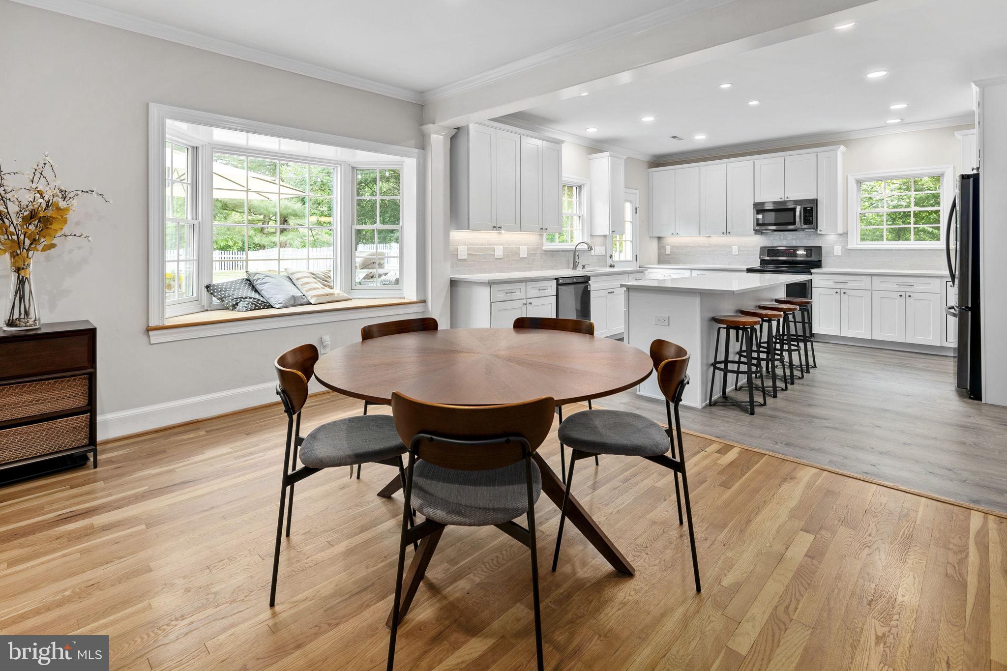 6916 Seven Locks Road Cabin John, MD 20818 - Photo 17 of 38 a view of a dining room with furniture and wooden floor