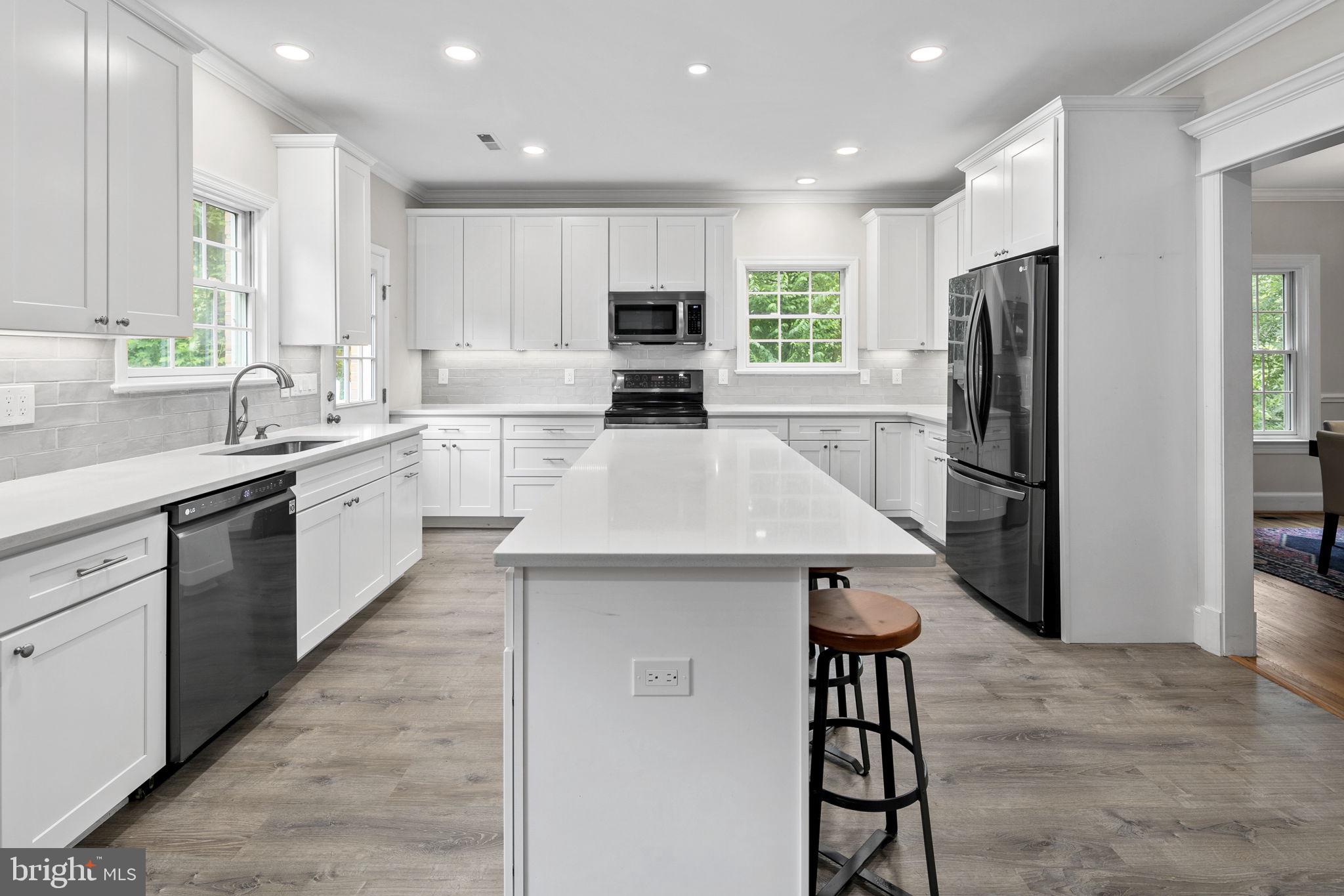 6916 Seven Locks Road Cabin John, MD 20818 - Photo 19 of 38 a kitchen with a sink stainless steel appliances and cabinets