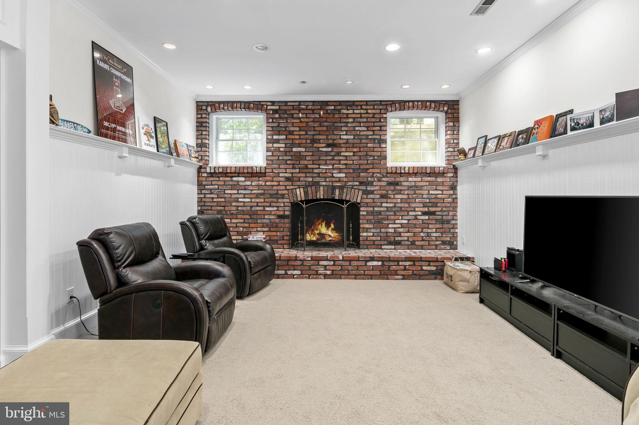 6916 Seven Locks Road Cabin John, MD 20818 - Photo 25 of 38 a living room with furniture and a fireplace